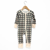 Plaid baby onesie on a hanger against a white background