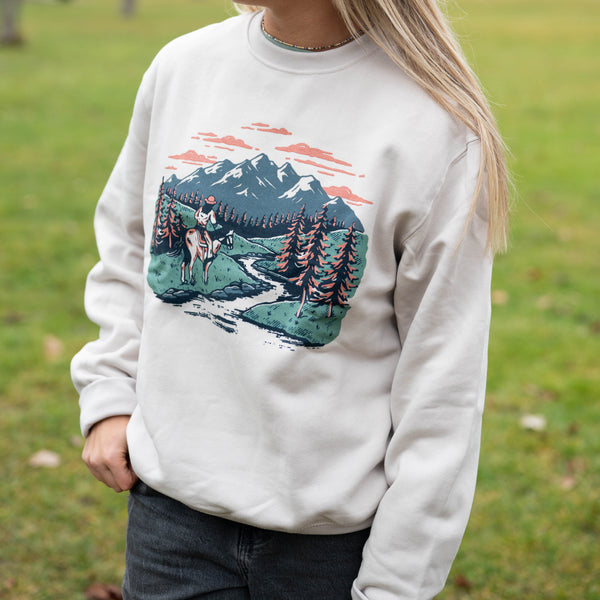 mountain scene with cowgirl riding horse pullover