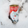 Can of Après Ski Cocoa Mix surrounded by snow and branches