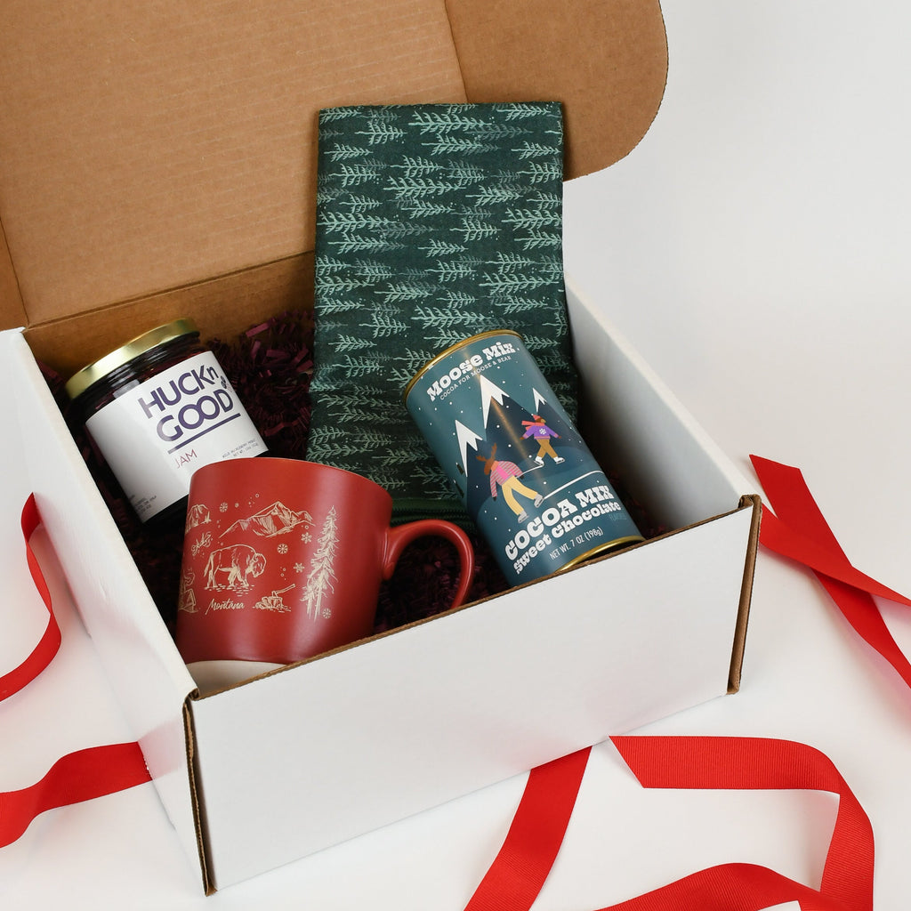 Gift box with tea towel, mug, hot cocoa and huckleberry jam