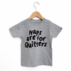 Gray t-shirt with 'Naps are for Quitters' text on a wooden hanger against a white background